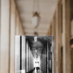 Exploring perspective using a black and white photo held in a modern corridor.